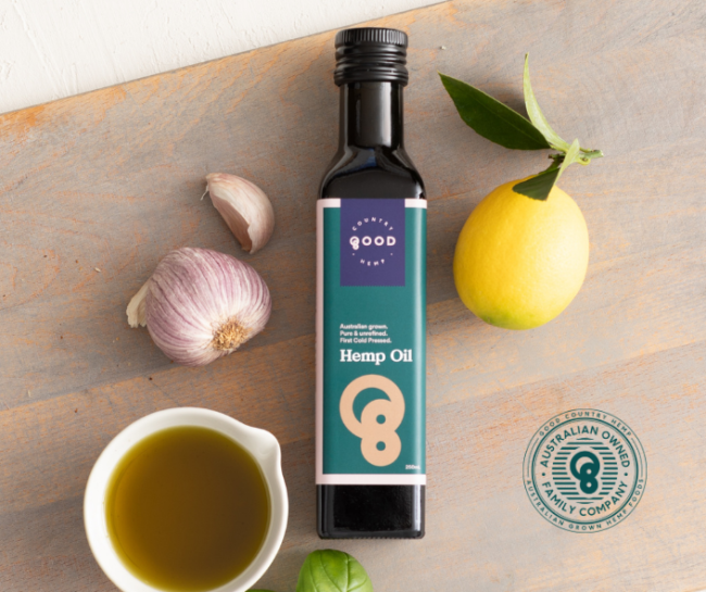 Good Country Hemp, hemp seed oil bottle, with open bowl of hemp seed oil next to the bottle.